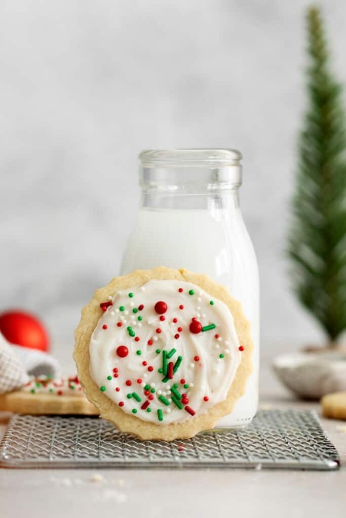 sugar cookie against glass of milk