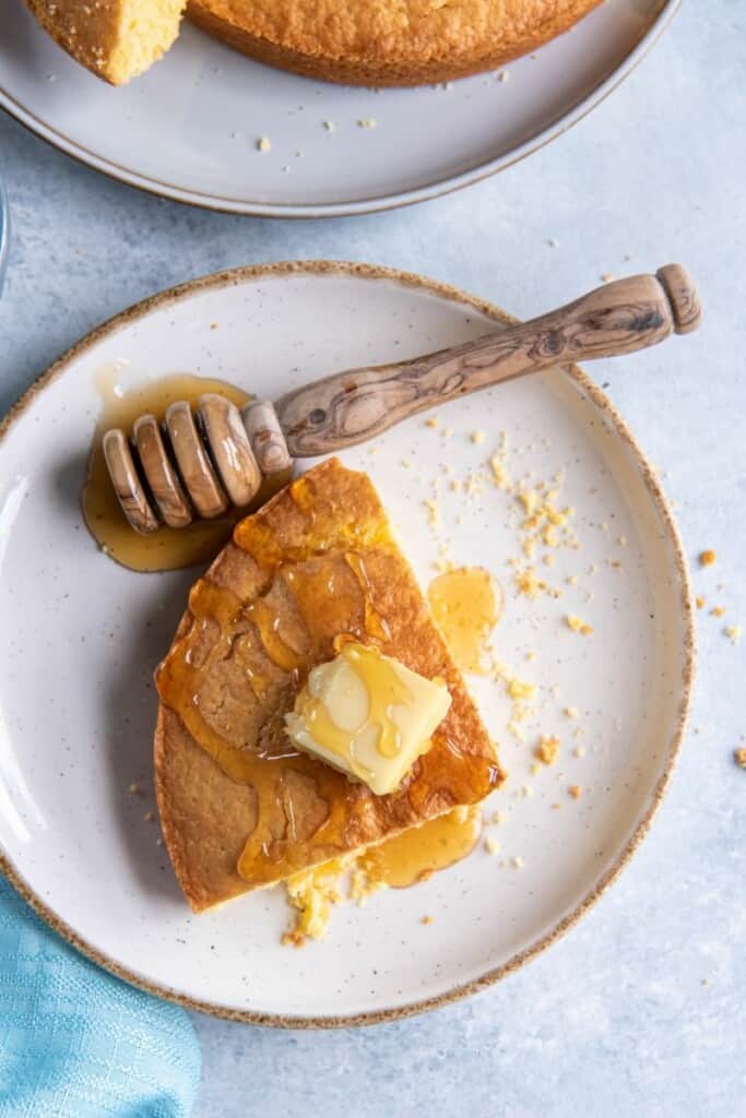 overhead shot of cornbread with butter and honey