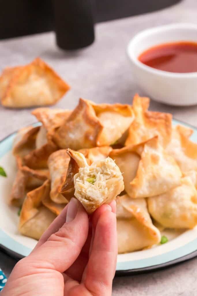 holding a crab rangoon