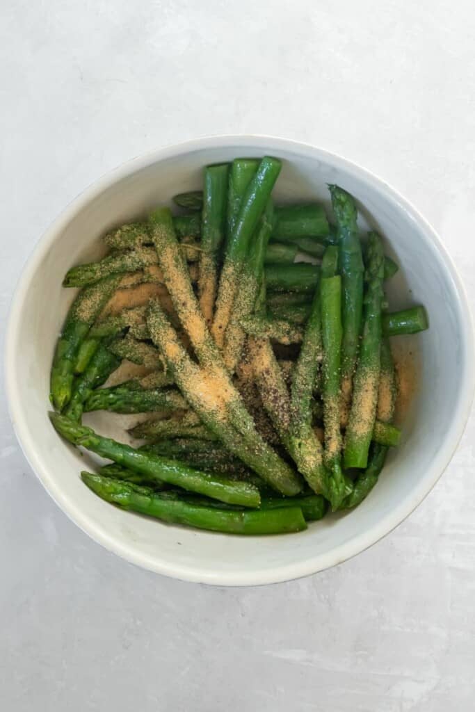 seasonings in bowl with asparagus