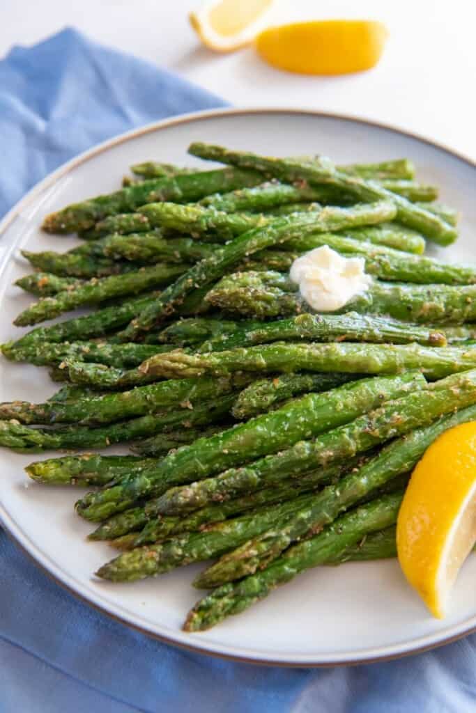 asparagus on a plate with a dollop of butter on top