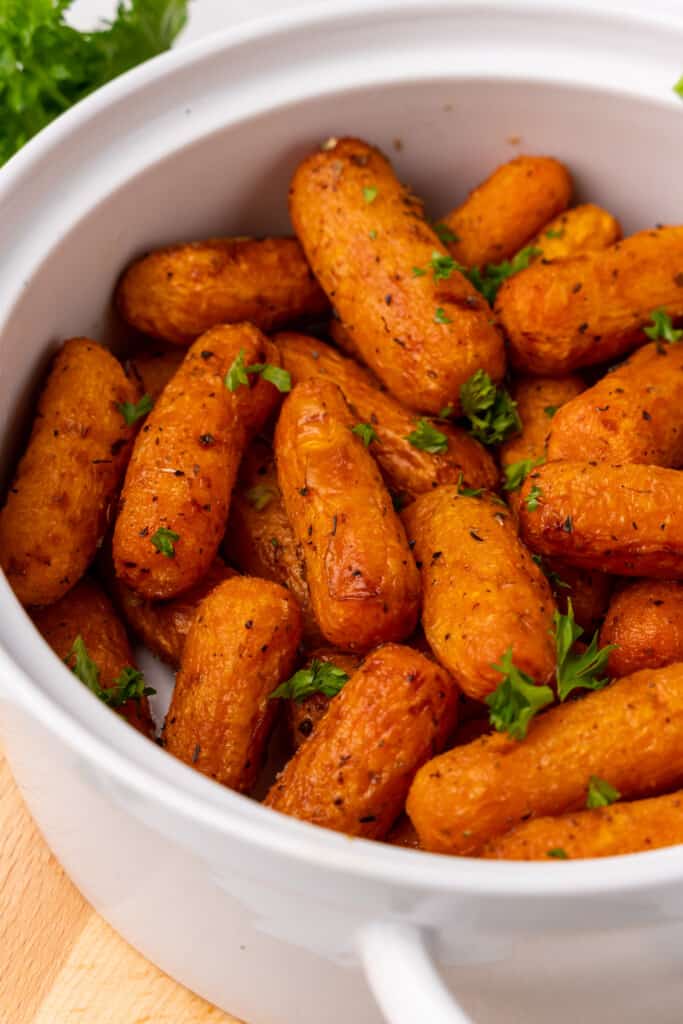 white bowl with cooked baby carrots