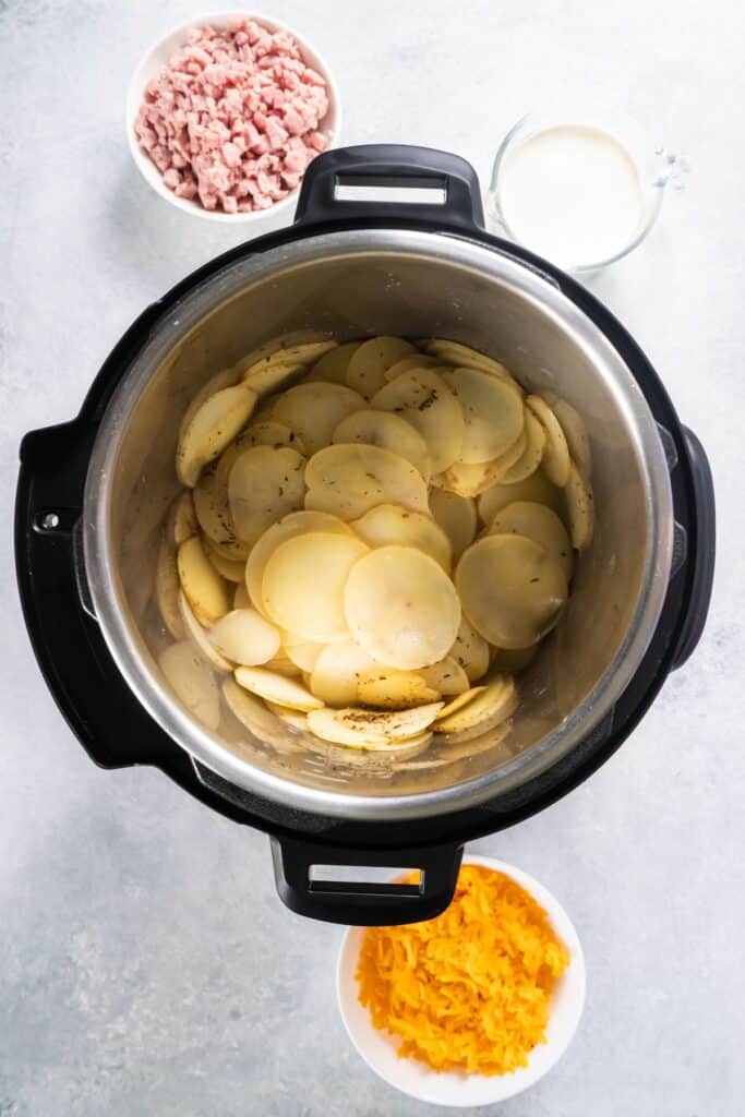 The scalloped potatoes in the Instant Pot to make some scalloped potatoes and ham.