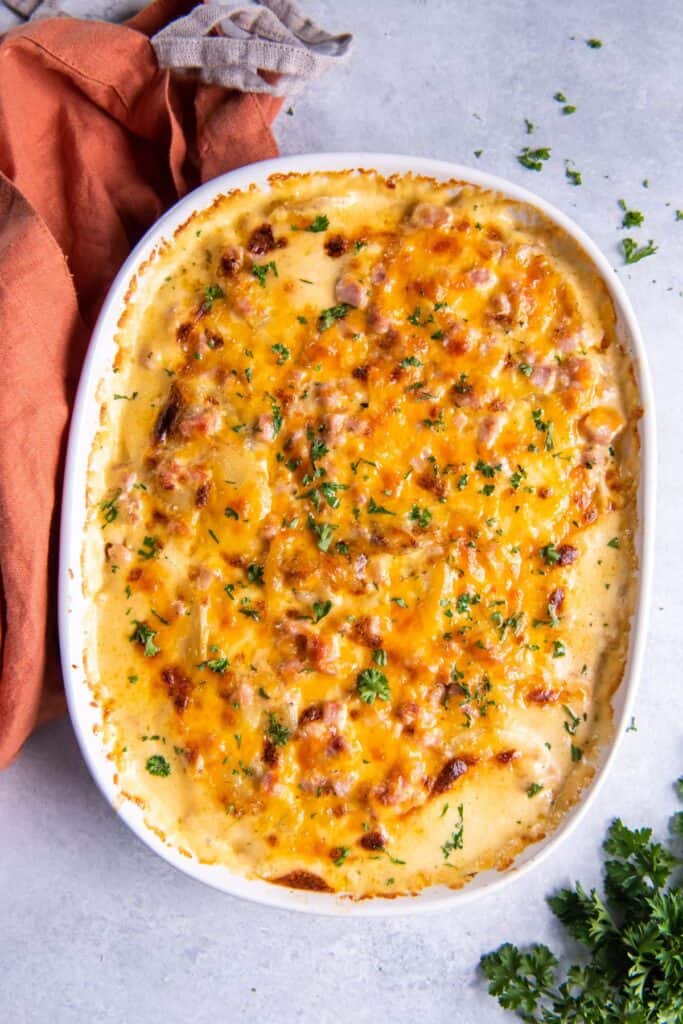 Instant pot ham and potatoes baked in a dish that's golden brown on top from being broiled.