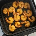 air fryer basket with cooked shrimp