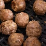 Close up of turkey meatballs in the air fryer basket.