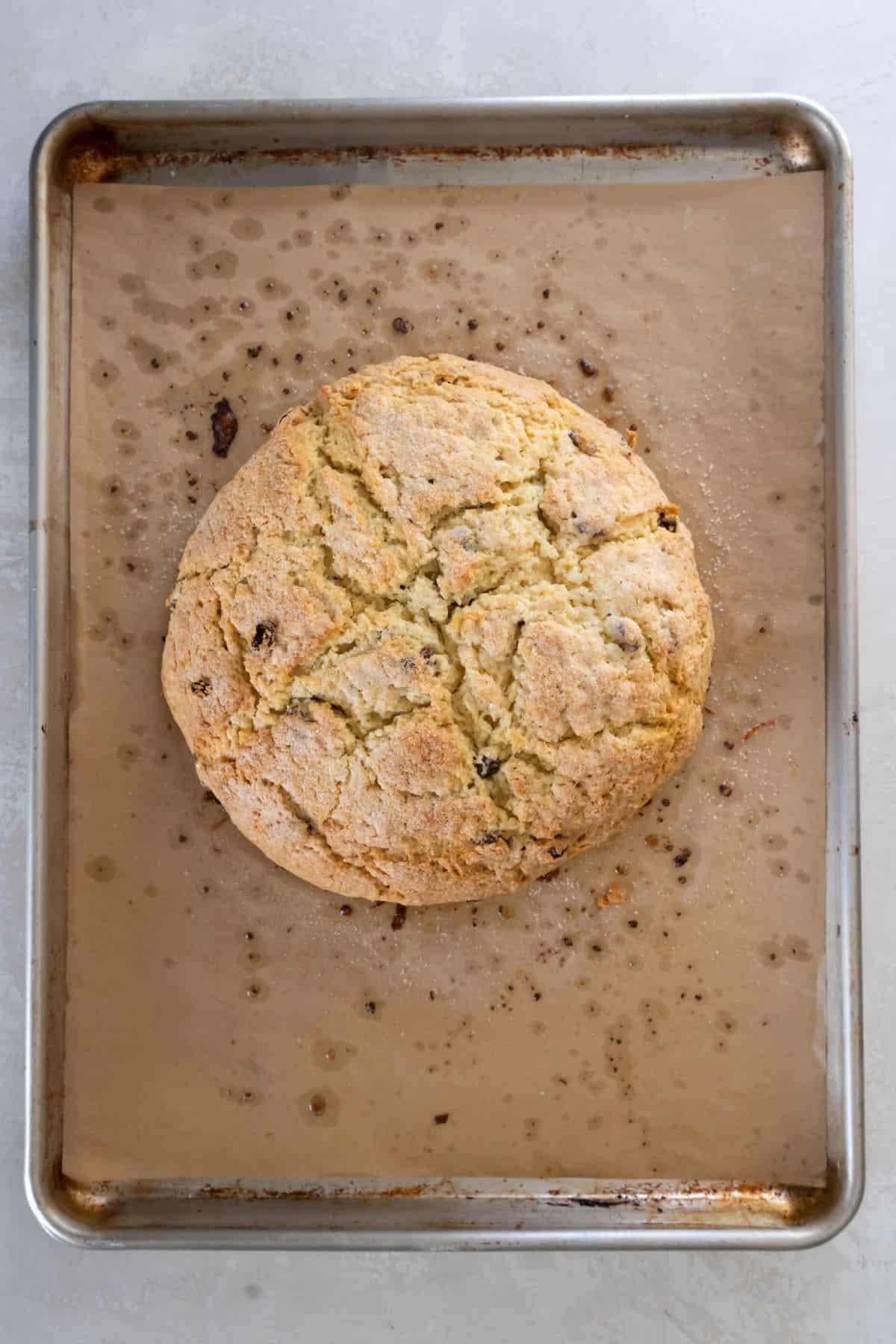 Irish soda bread without buttemilk just removed from the oven on a baking sheet.