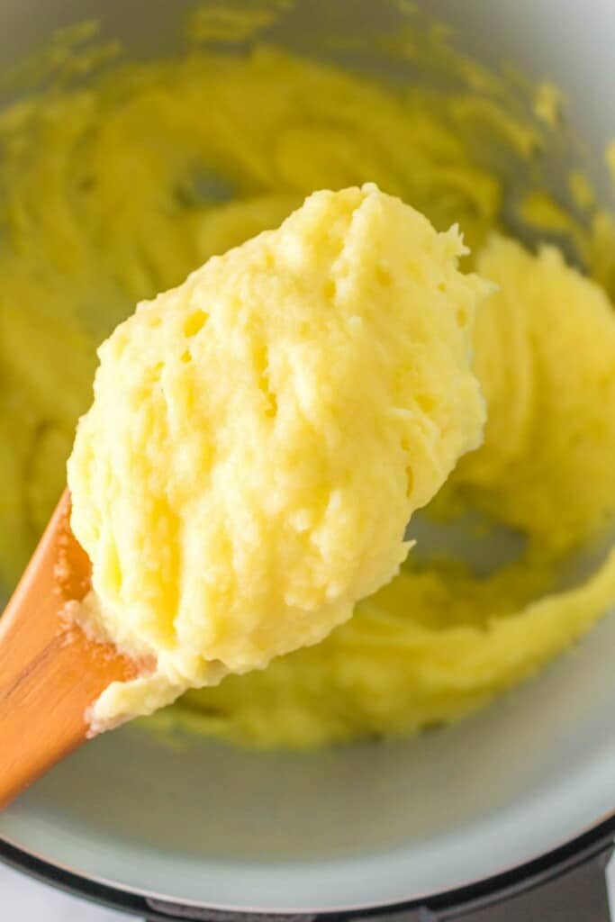 mashed potatoes on wooden spoon