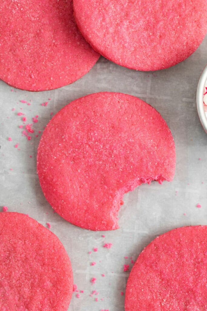 pink sugar cookies with bite out of it