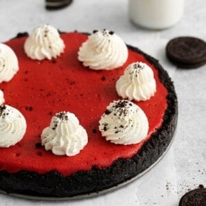 Red Velvet Oreo Cheesecake served on the springform pan with oreos around it