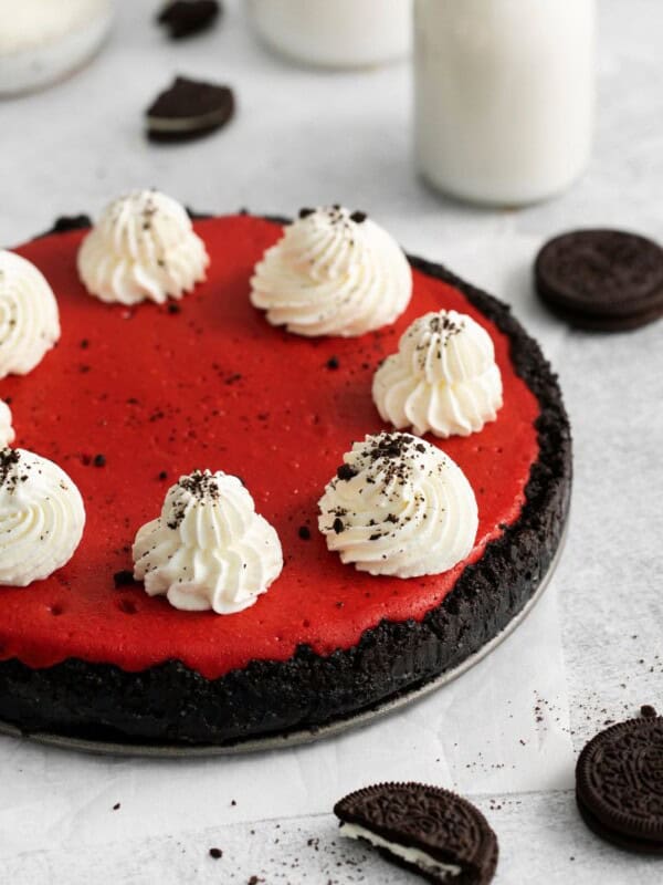 Red Velvet Oreo Cheesecake served on the springform pan with oreos around it