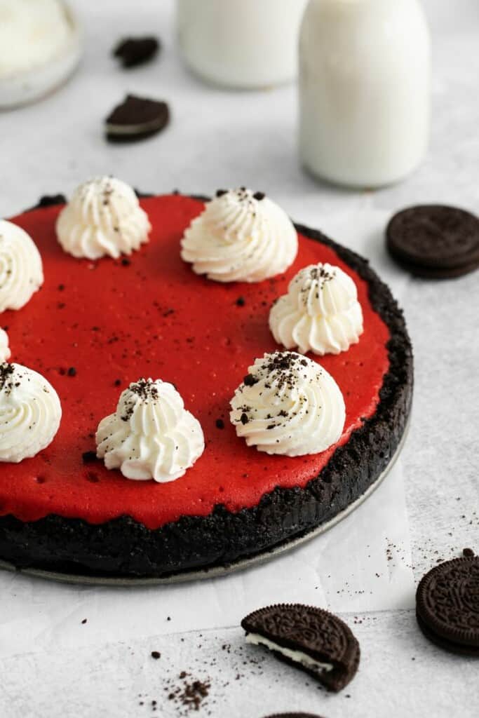 Red Velvet Oreo Cheesecake served on the springform pan with oreos around it