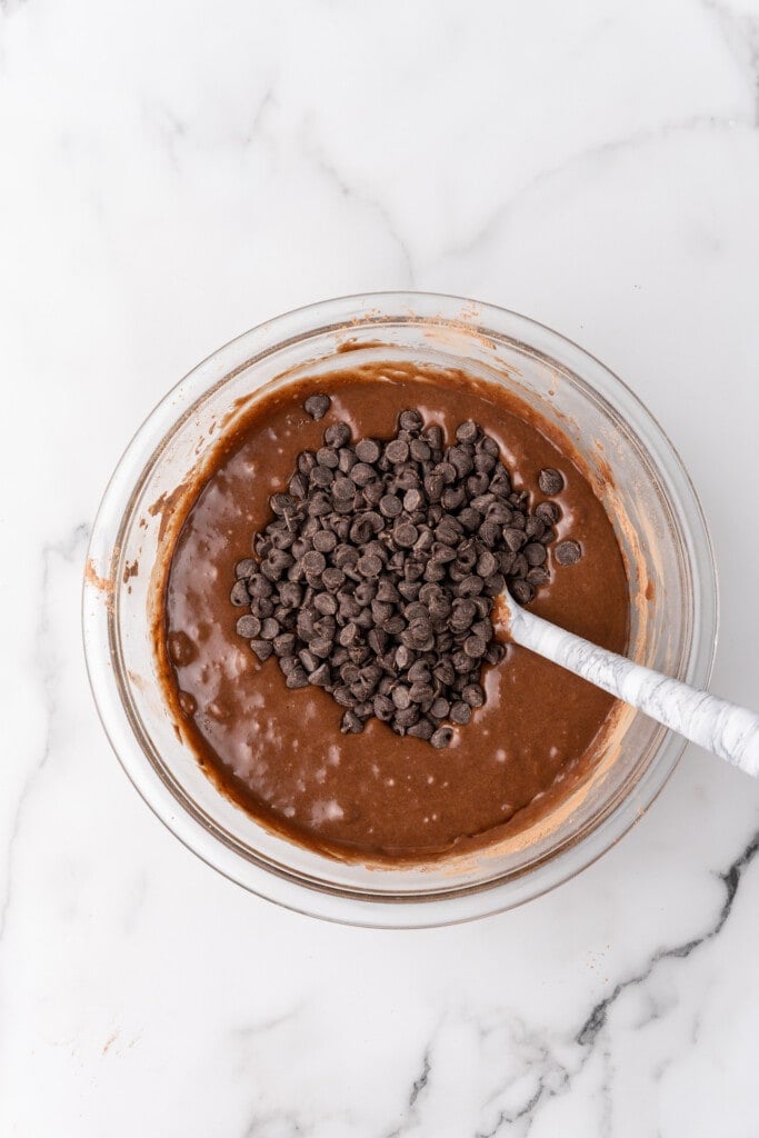 folding chocolate chips in brownie batter