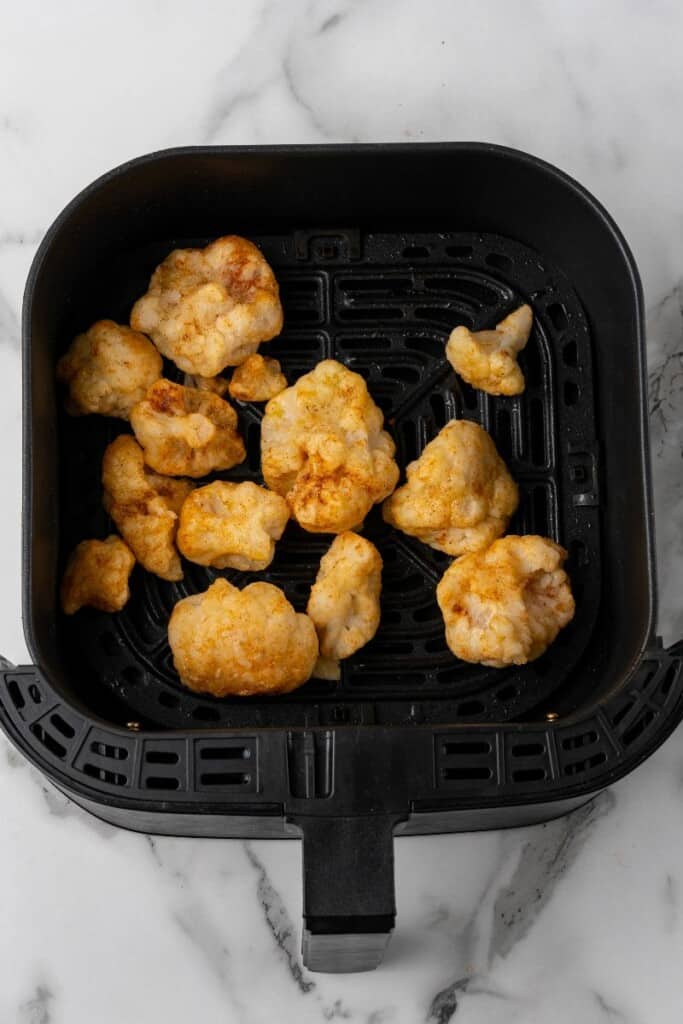 cauliflower in an air fryer basket