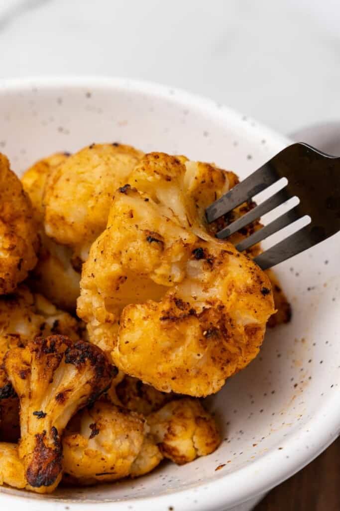 fork in a piece of cauliflower