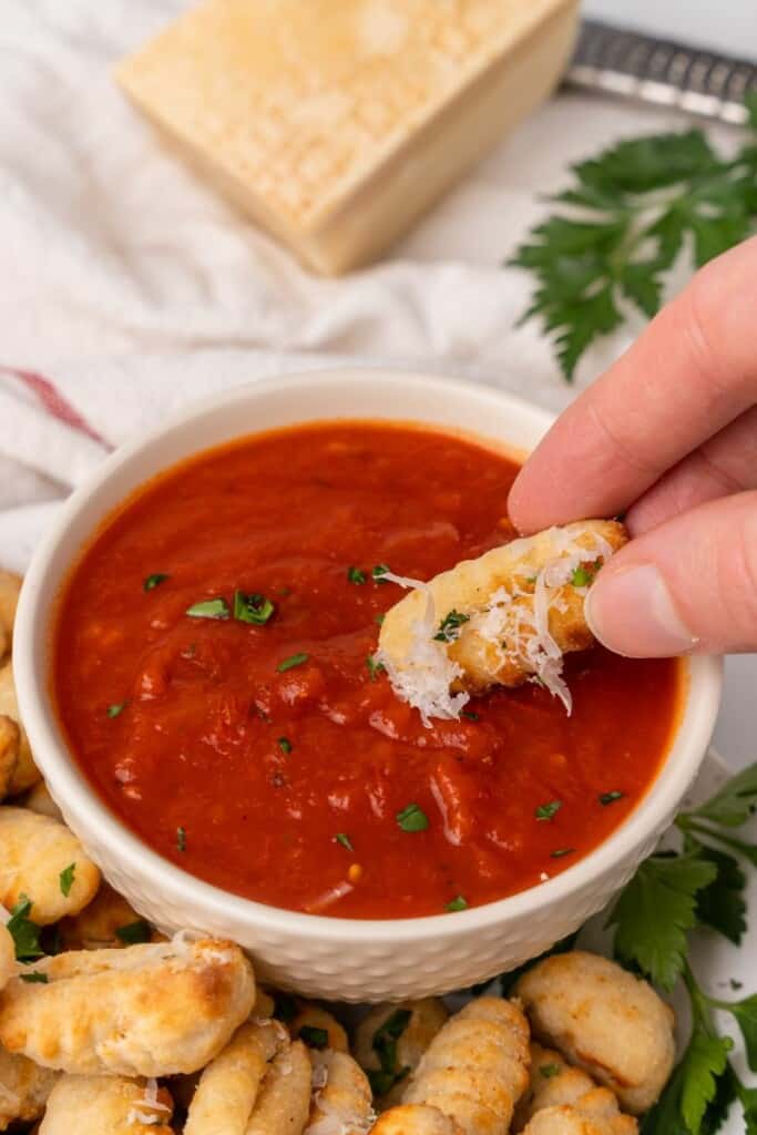 dipping gnocchi in marinara sauce