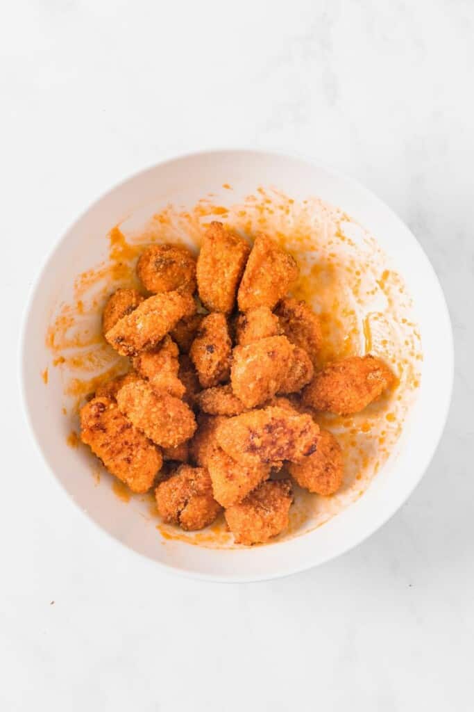 adding chicken to marinade