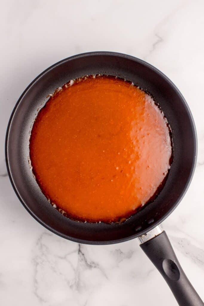 Buffalo sauce on the stove heating up for the buffalo chicken sandwiches.