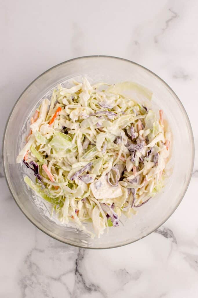 Coleslaw mix and ranch mixture mixed together in a bowl.
