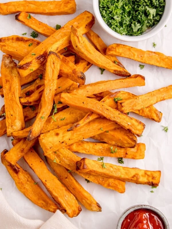 Air fryer sweet potato fries from overhead with crispy pieces.