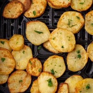 Air fryer sliced potatoes in air fryer basket