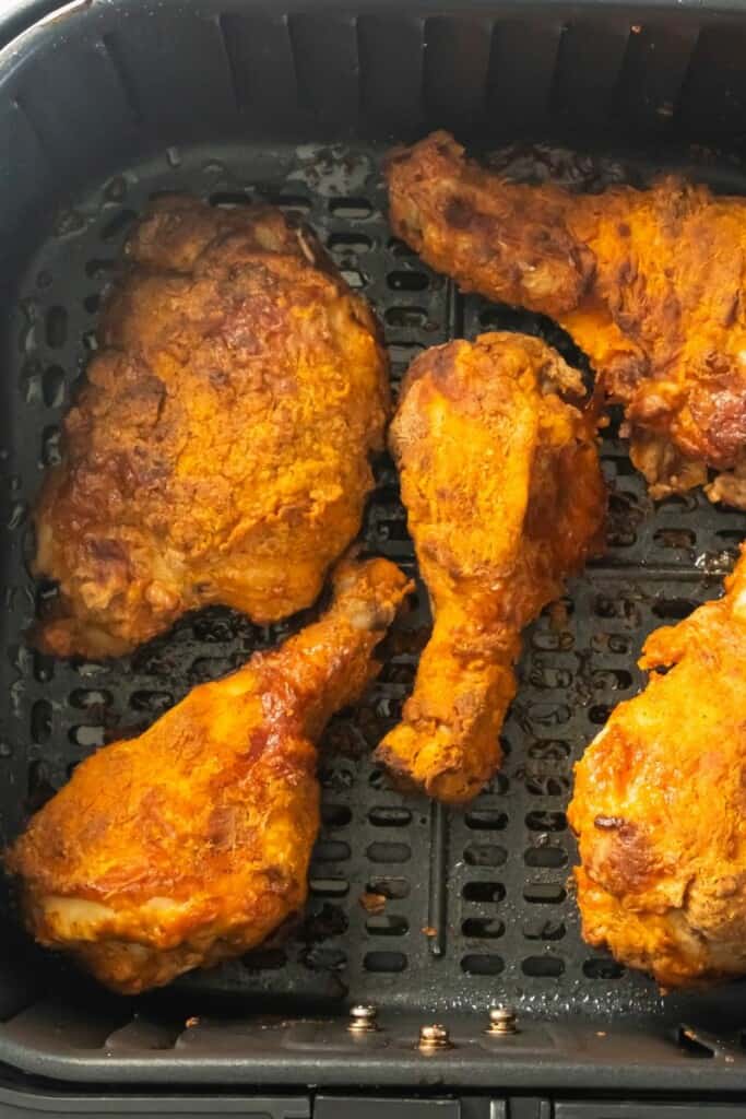 Reheated fried chicken in air fryer basket