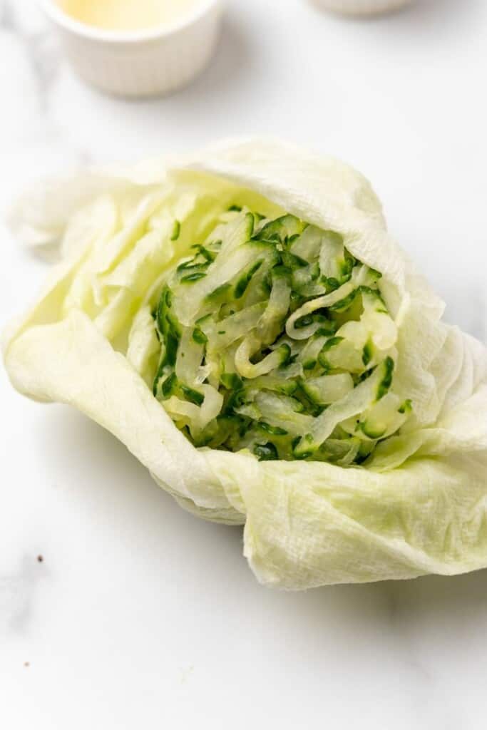 squeezing cucumber to remove water