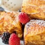 several pieces of hawaiian french toast rolls on a plate with fresh berries