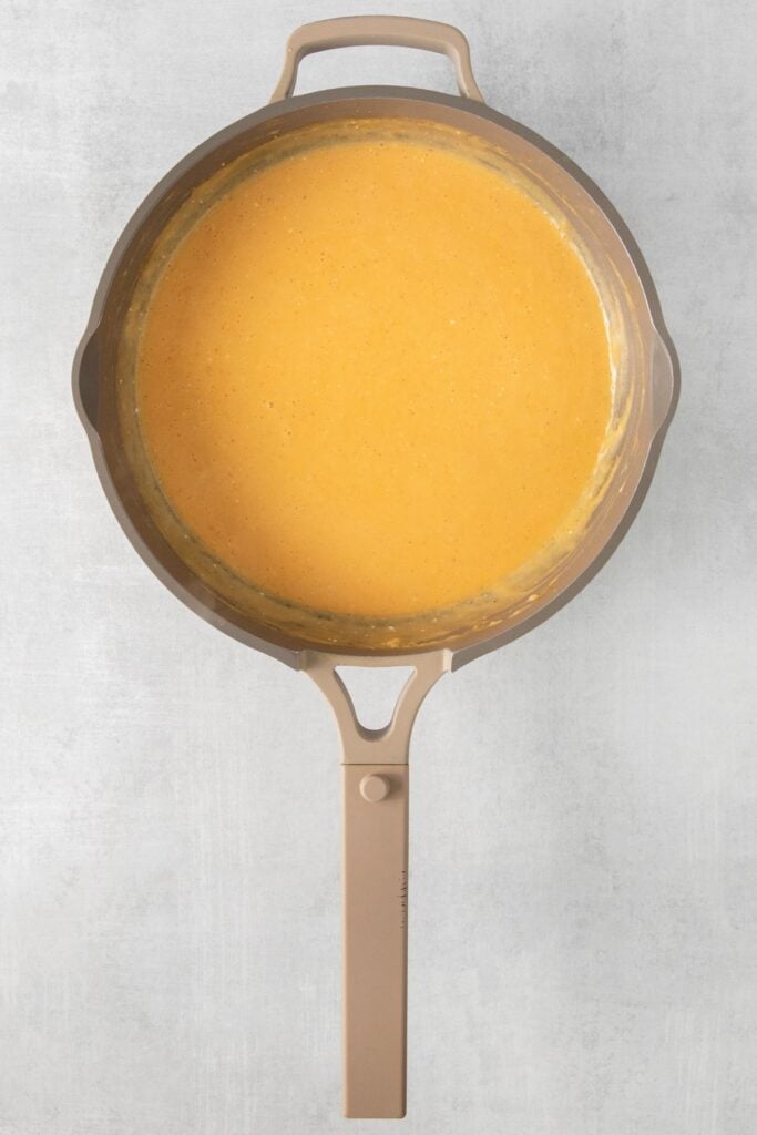 Cheese sauce in a pot made without milk for mac n cheese.