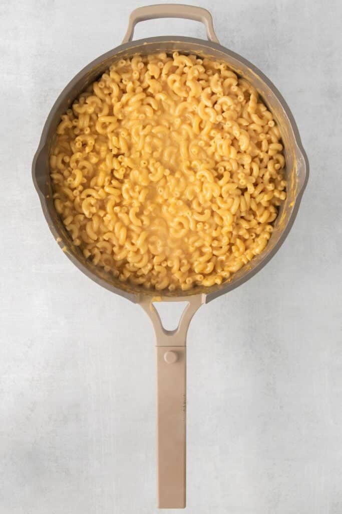 Macaroni and cheese made without milk in a pot.