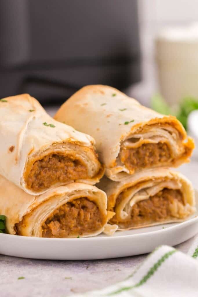 2 burritos both cut in half stacked on top of each other