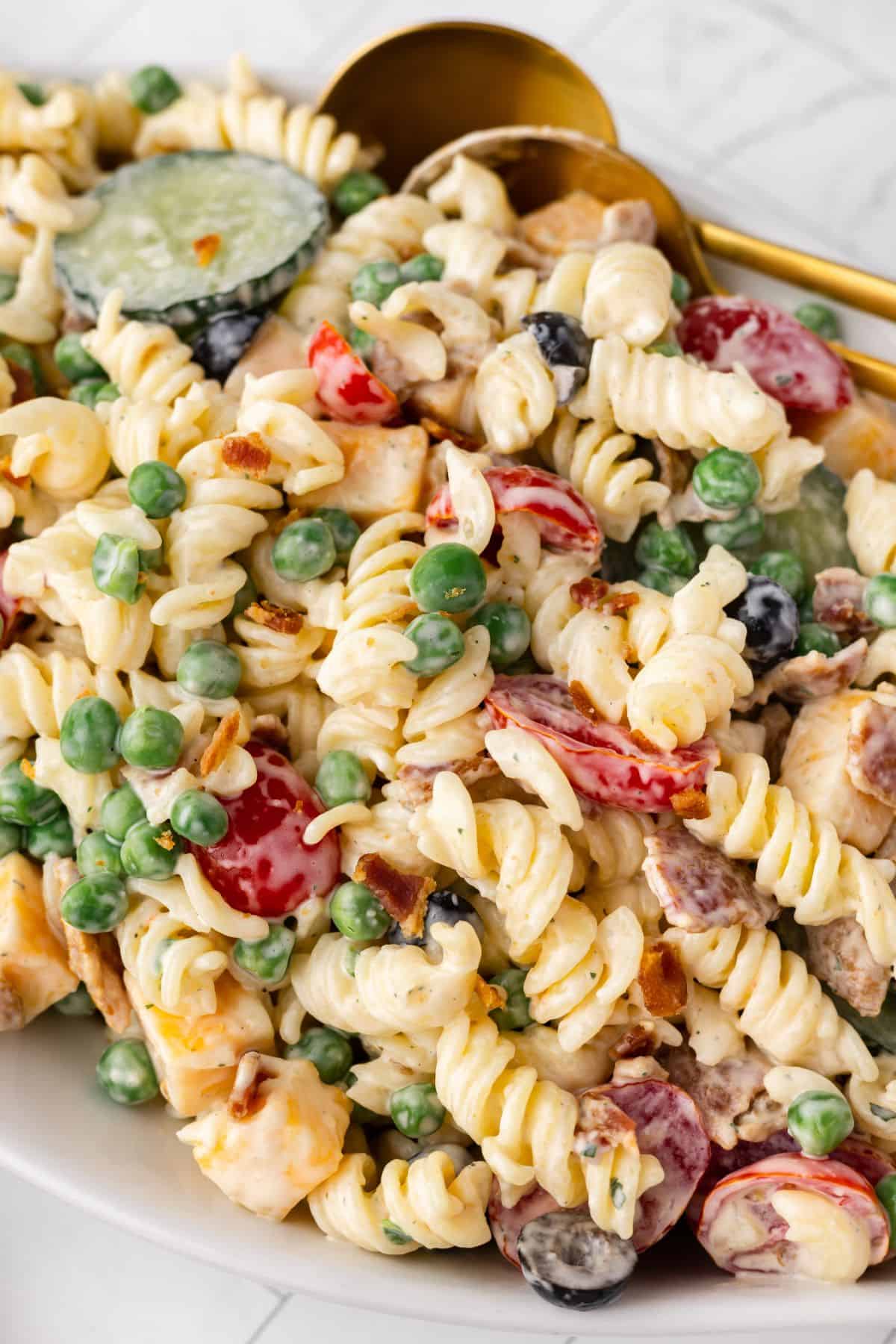 Closeup to see the pasta salad with bacon and ranch in a serving bowl.