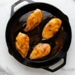 Cooked chicken breast in cast iron skillet