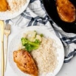 Overhead view of Chicken Breast rice, broccoli, and cauliflower on a white plate.