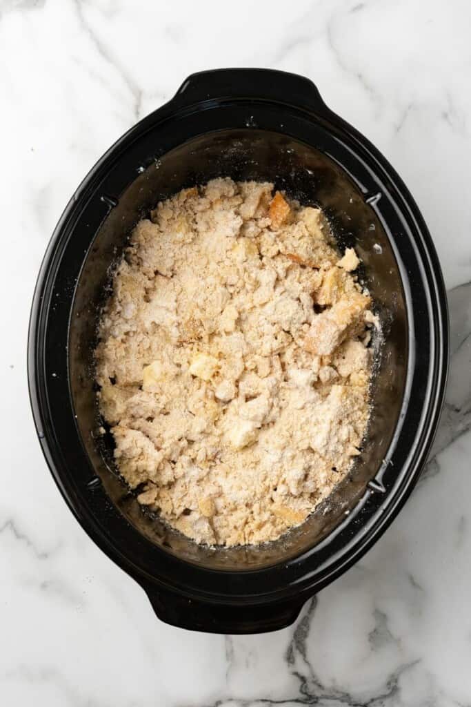 Overhead view of ingredients in the crockpot for crockpot french toast casserole.