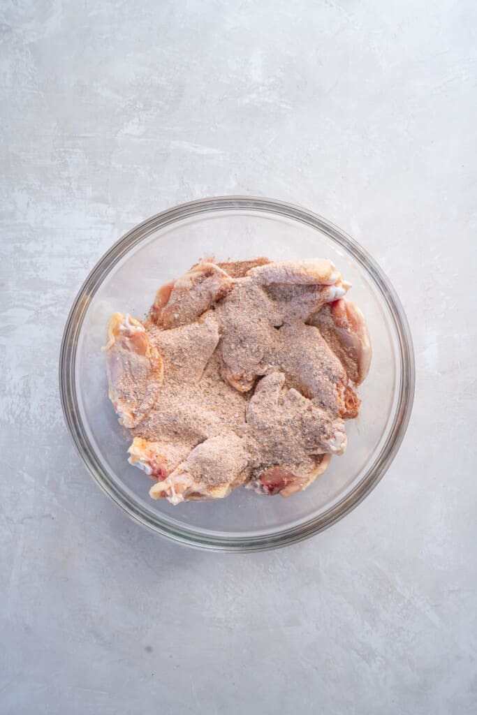 Overhead view of chicken wings with dry rub.