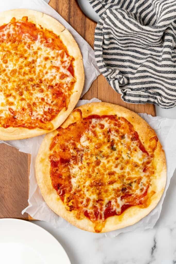 Overhead view of two air fryer tortilla pizzas ready to be enjoyed.