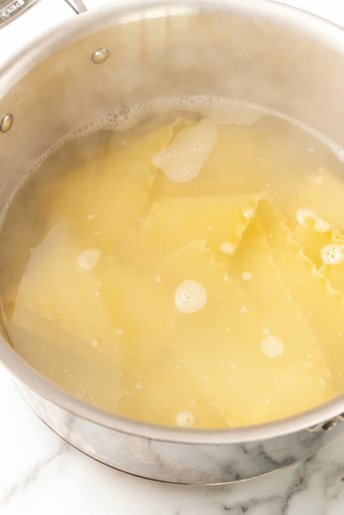 A large gray pot of salted boiling water.