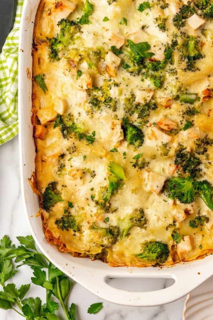 Close view of chicken and broccoli casserole in a white 9x13 baking dish.