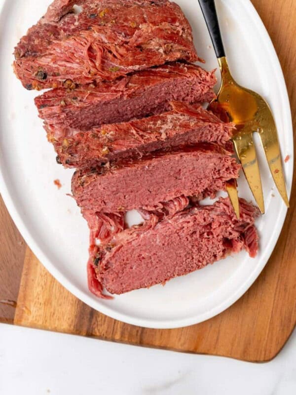 Sliced corned beef on a white plate.