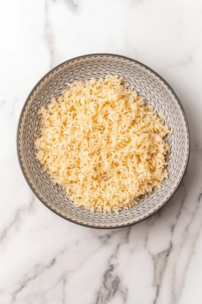 Single serving of rice in a gray bowl, waiting on additional toppings.