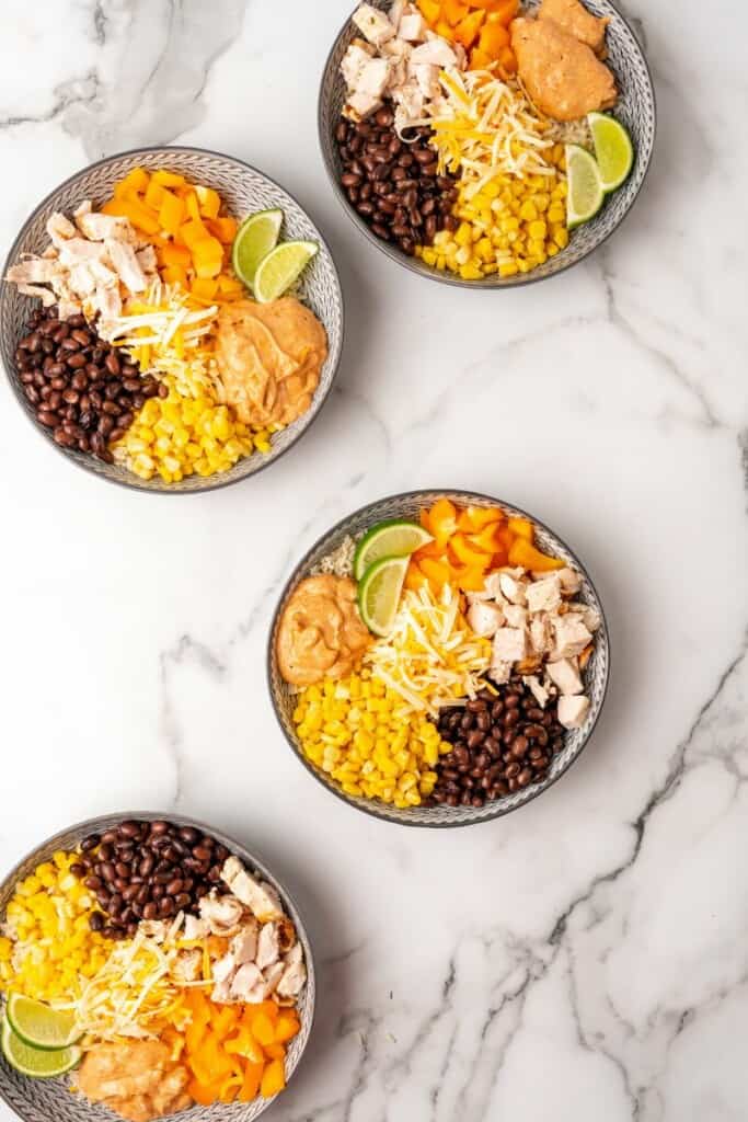 Overhead view of 4 southwest bowls on a white marble background.