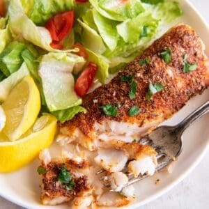 Air fryer frozen food that is cooked on a plate with pieces taken off to see the flakiness.