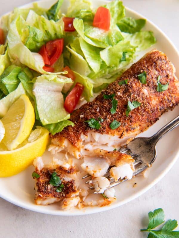 Air fryer frozen food that is cooked on a plate with pieces taken off to see the flakiness.