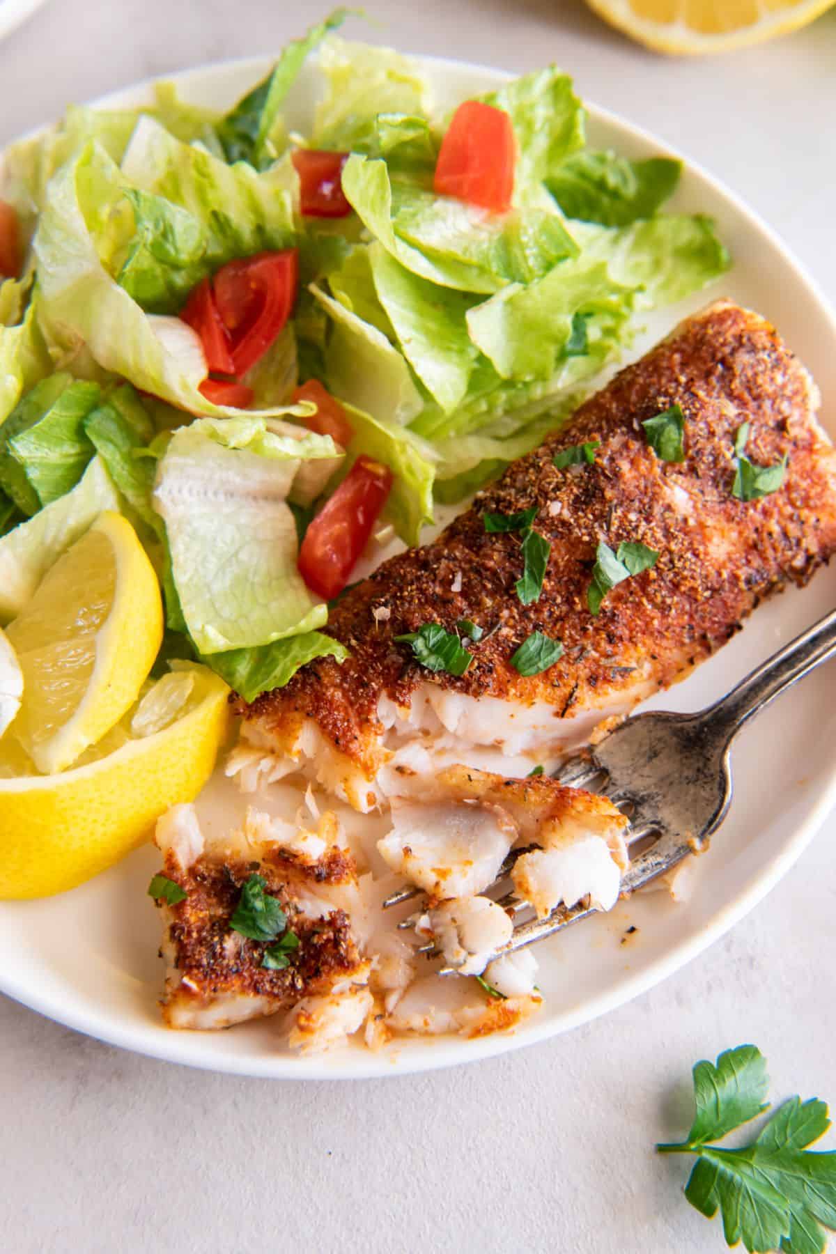 Air fryer frozen food that is cooked on a plate with pieces taken off to see the flakiness.