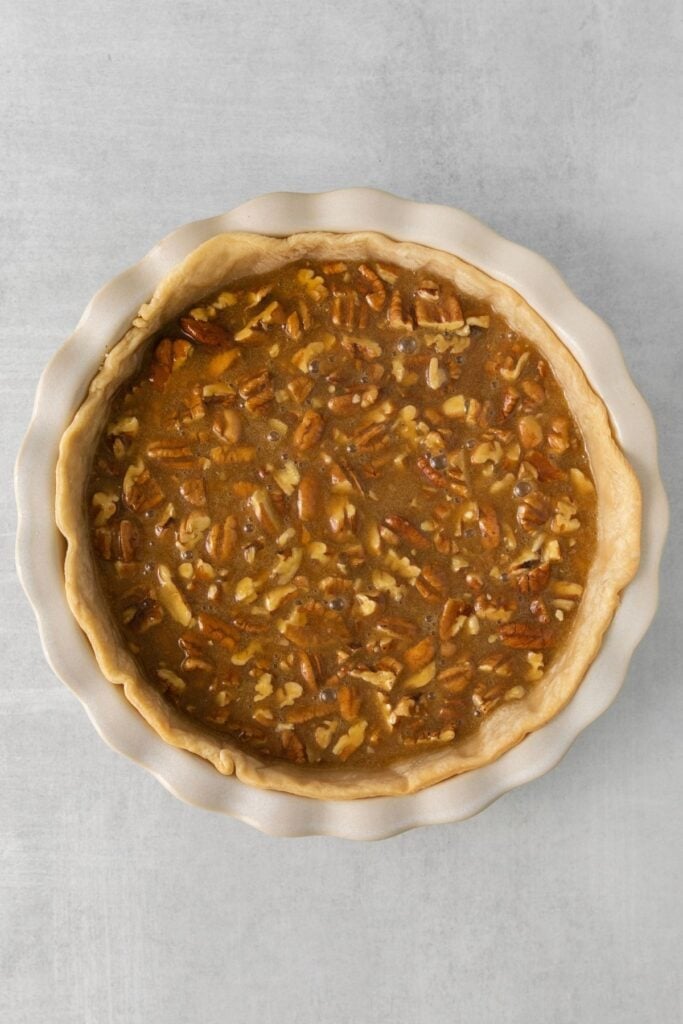 Pecan pie recipe without corn syrup filing in the pie crust about to be baked.