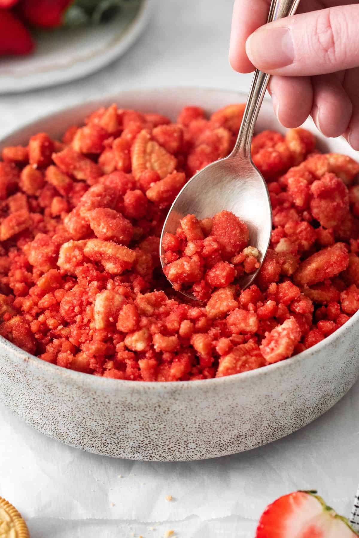 Close up of the strawberry crunch recipe in a bowl with a spoon.