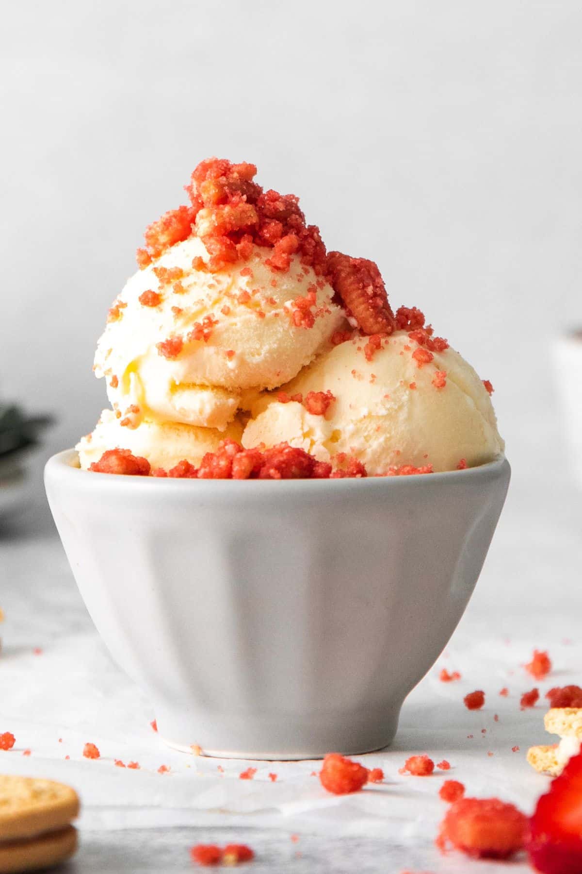 The strawberry crunch topping on top of vanilla ice cream in a bowl.