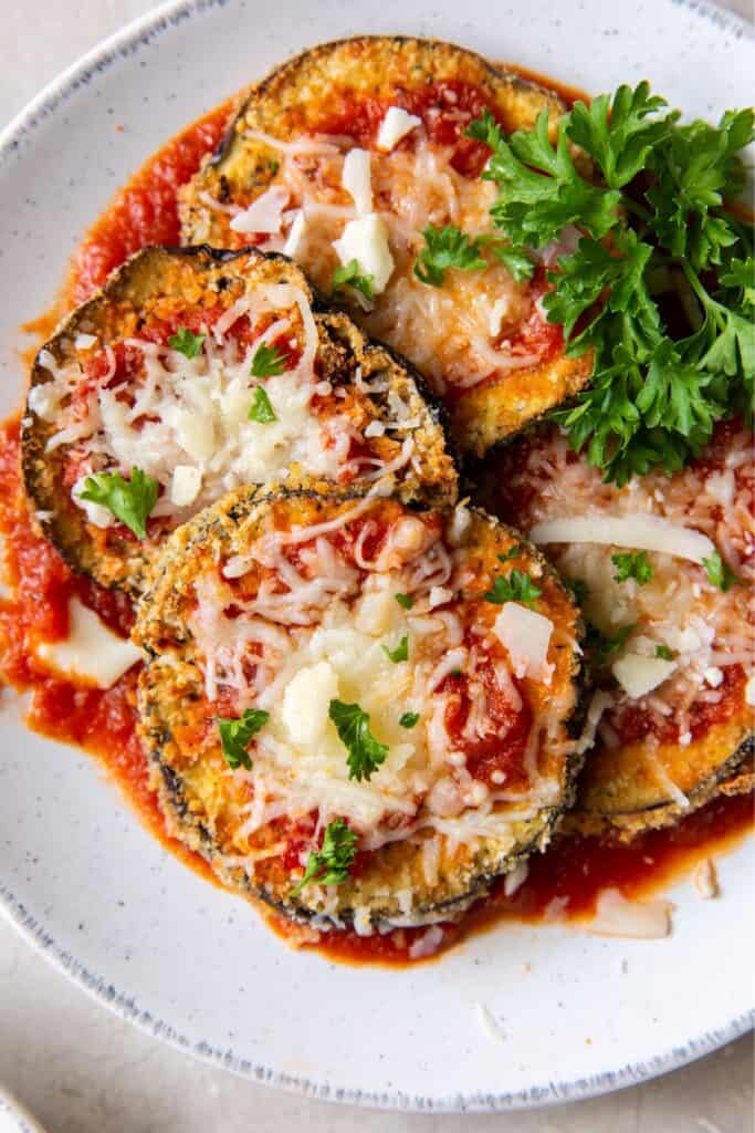 Air fryer eggplant Parmesan on a plate side by side.