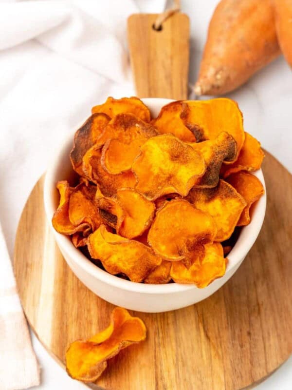 A white bowl filled with sweet potato chips.